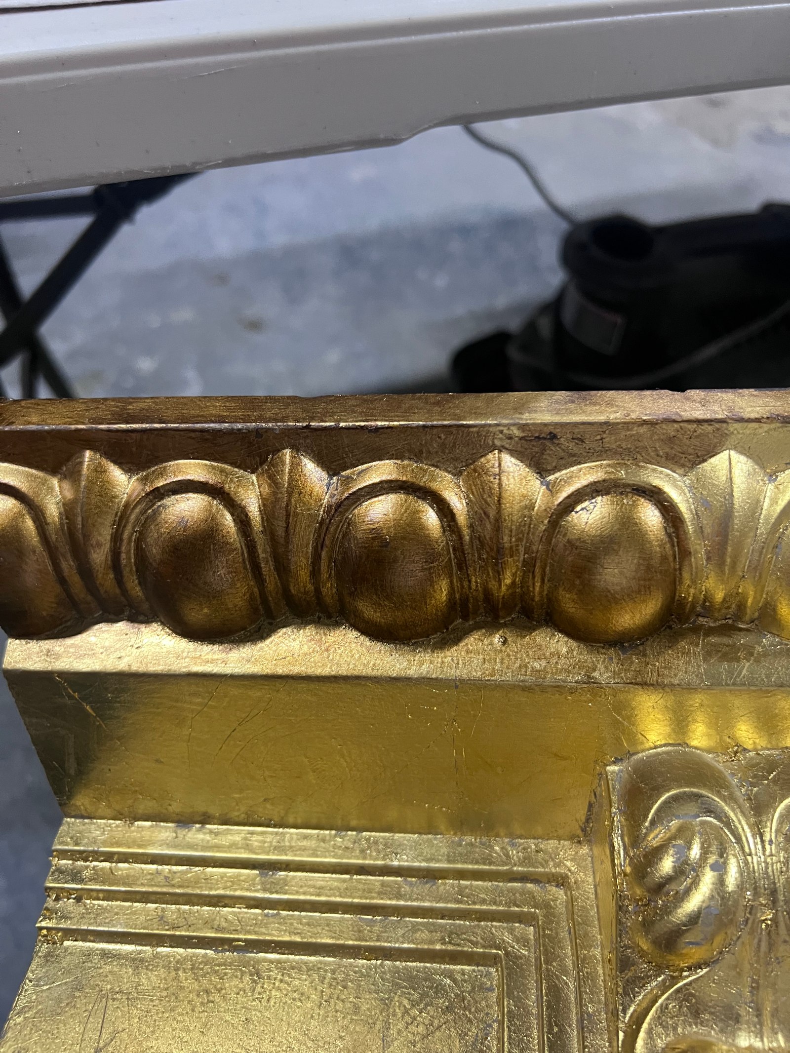Gold-leaf finish on carved architectural trim.