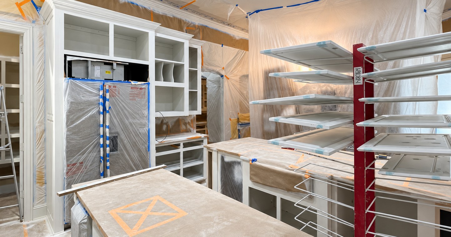 Protected cabinet work area with doors on drying racks.
