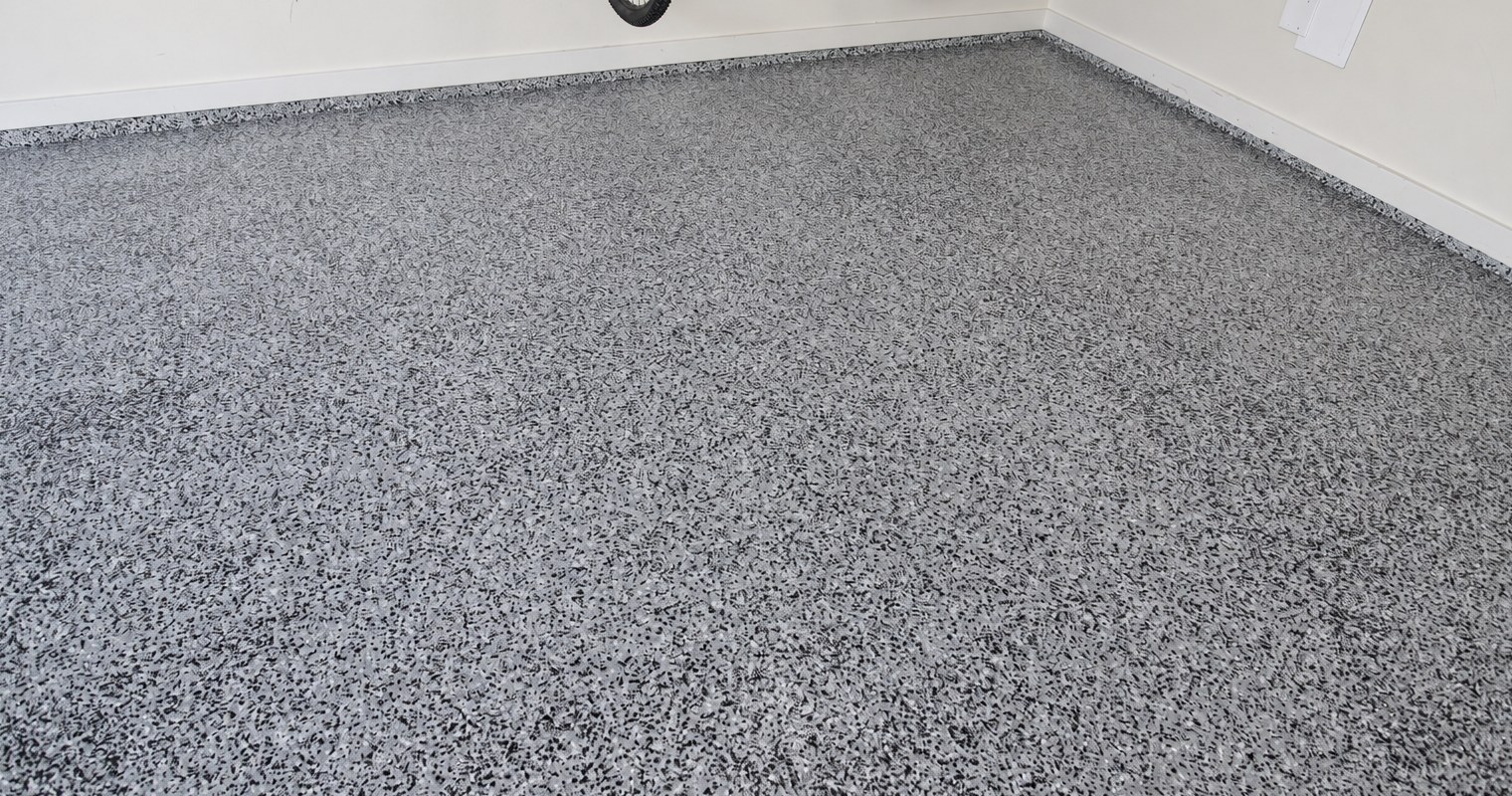 Gray speckled garage floor with a textured finish.