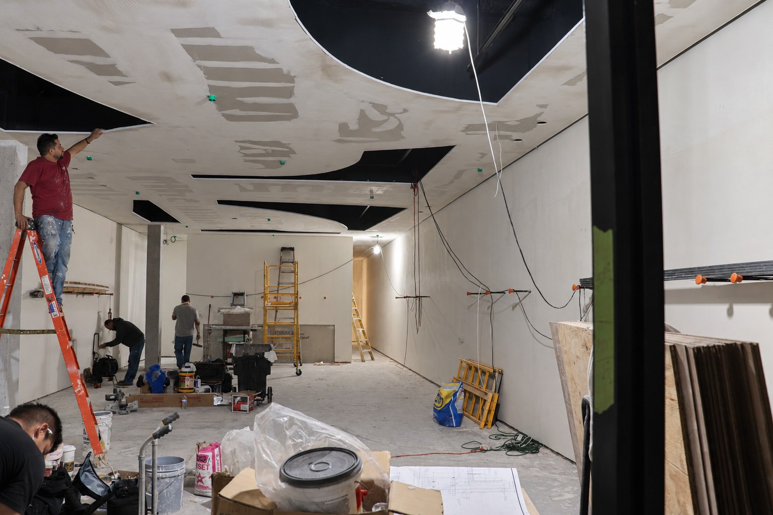 Workers during wall and ceiling preparation.