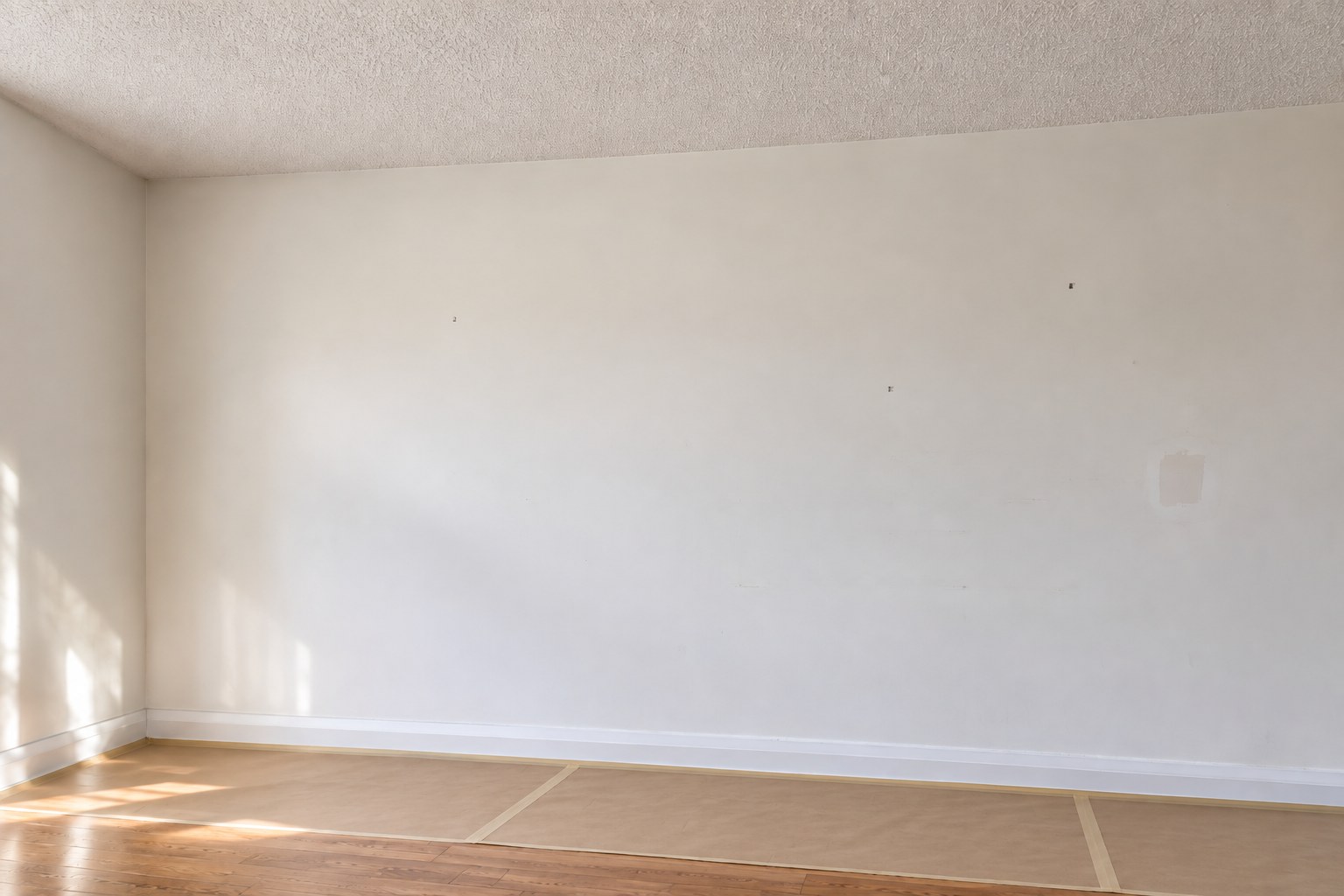 Plain wall with small surface imperfections before preparation.