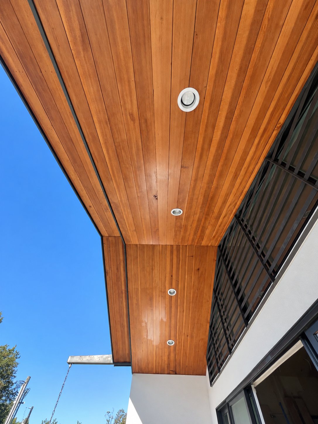 Timber soffit with recessed lighting and visible wood grain.